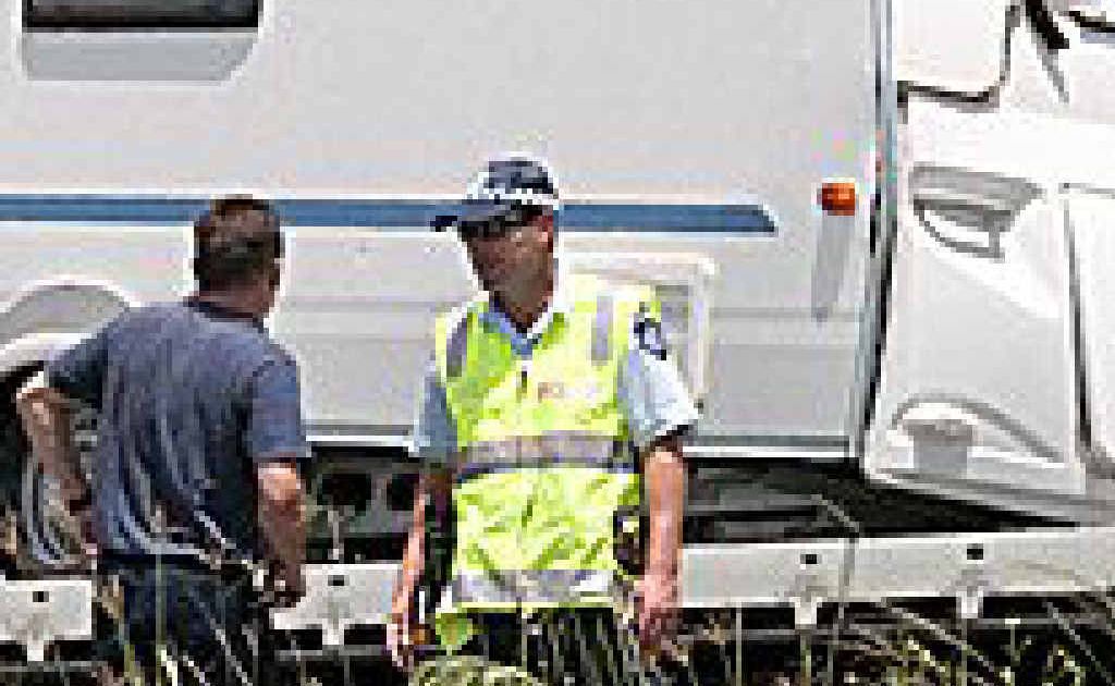 Sgt Greg Burton pictured at the scene of an overturned caravan at Missen Flat on Monday. Sgt Greg Burton pictured at the scene of an overturned caravan at Missen Flat on Monday.